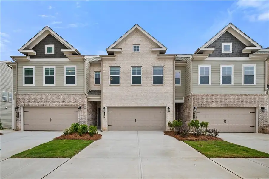 Front exterior of a new home in Langley Overlook, Loganville, GA, highlighting curb appeal (Image 1). Front exterior of a new home in Langley Overlook, Loganville, GA, highlighting curb appeal (Image 1).