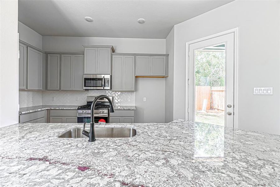 Just look at the details in the granite countertop! With hints of purple, it really adds a pop of color to the home.