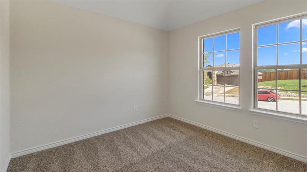 Carpeted empty room with baseboards Carpeted empty room with baseboards