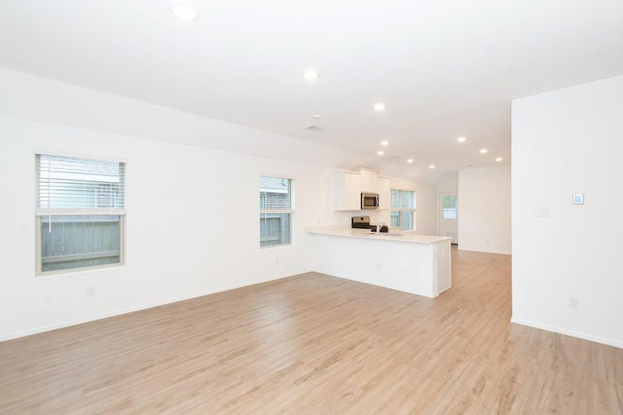 Spacious open layout with a seamless flow into the modern kitchen.