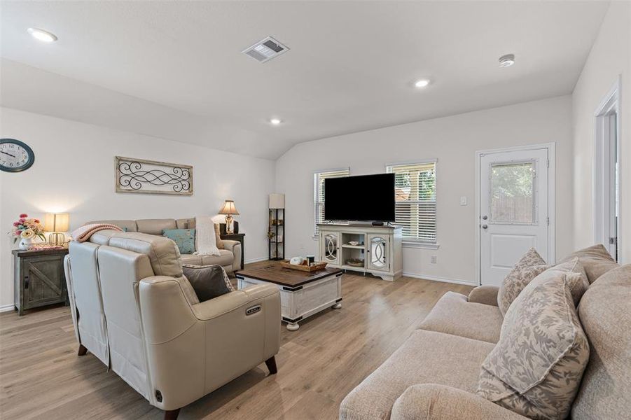Spacious open-layout living area with modern recessed lighting and seamless flow into the kitchen and dining spaces. Spacious open-layout living area with modern recessed lighting and seamless flow into the kitchen and dining spaces.