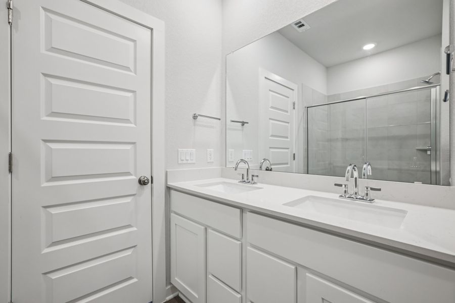 A bathroom with a large mirror.