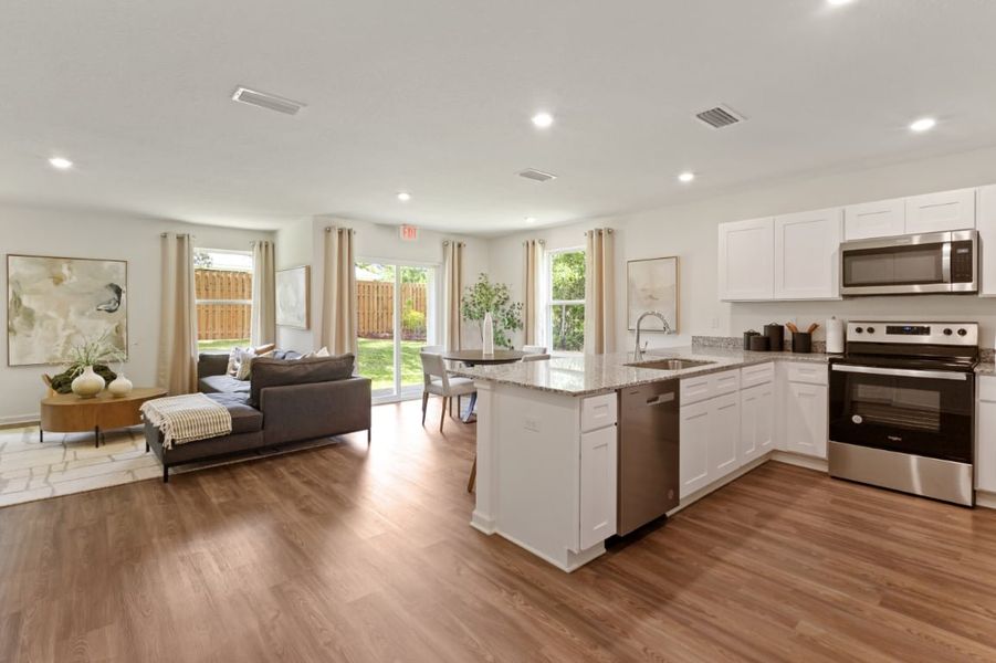 A large kitchen with a wood floor. A large kitchen with a wood floor.