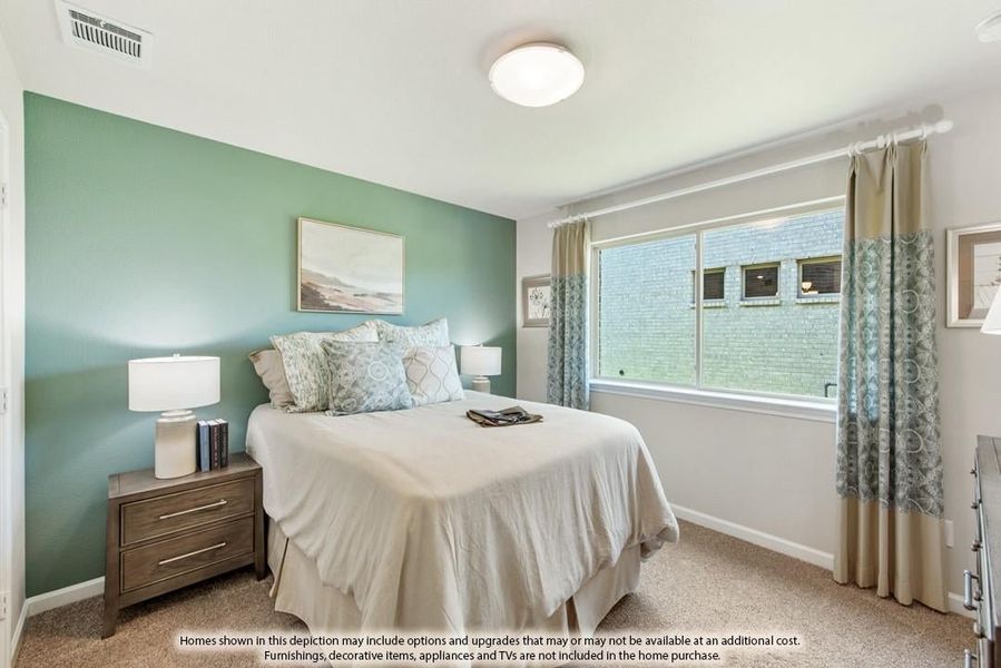 Bedroom with green accent wall, carpet flooring, and large window with curtains