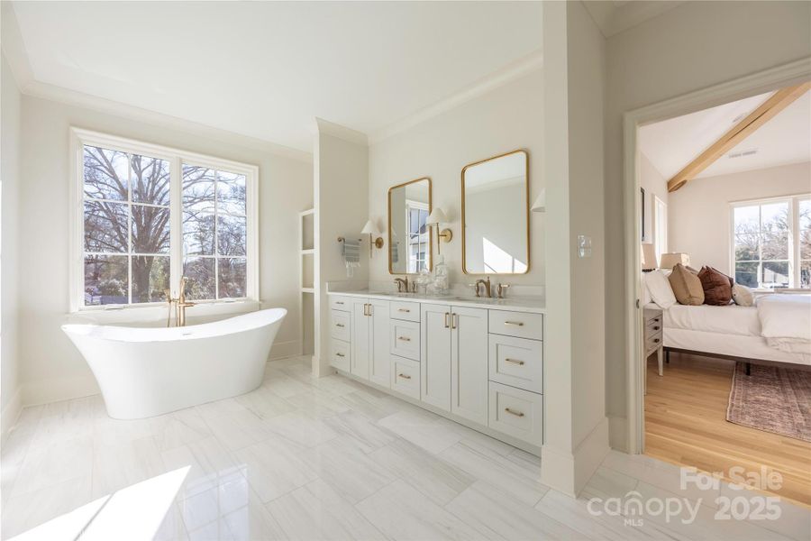 Spa-like Primary Bathroom with Soaking Tub, Large Shower, & Expansive Walk-in Closet.