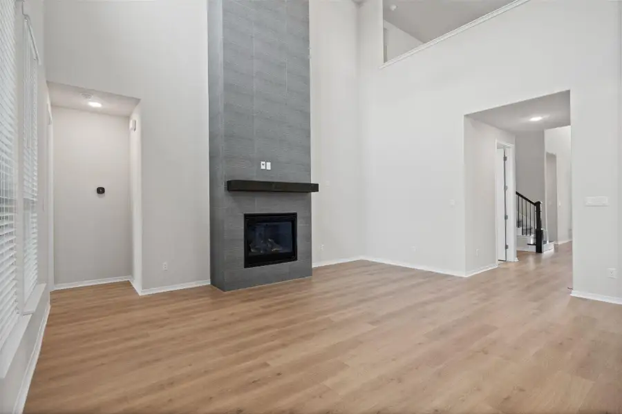 Family Room with soaring ceiling & fireplace