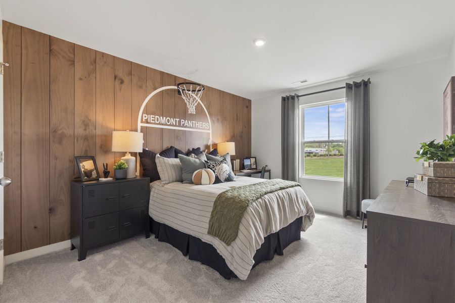 A bedroom with a bed and a desk.