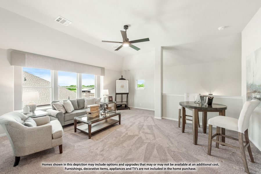 Open living room with vaulted ceiling, ceiling fan, gray sofas, and dining area on carpet flooring Open living room with vaulted ceiling, ceiling fan, gray sofas, and dining area on carpet flooring