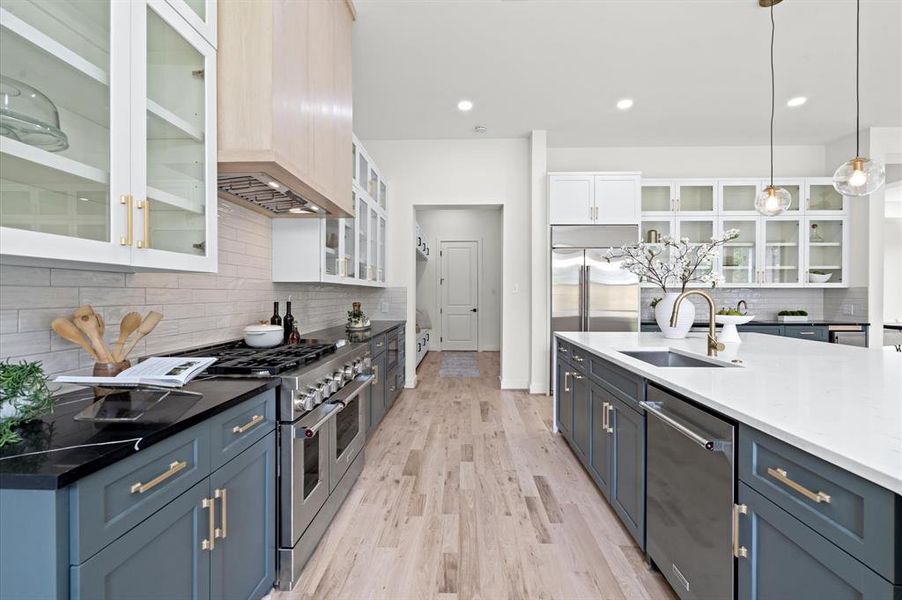 Kitchen views that lead to the mud room, garage, and pantry.