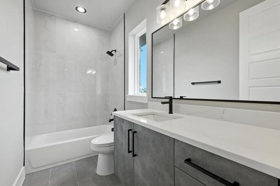 Bathroom featuring vanity,  shower combination, and tile patterned floors