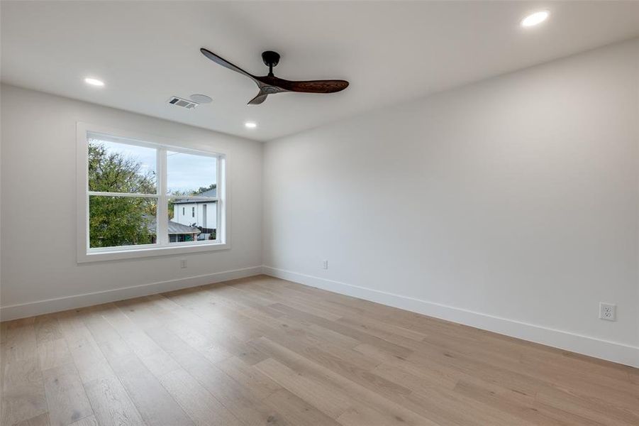 Empty room featuring light wood finished floors, recessed lighting, and ceiling fan