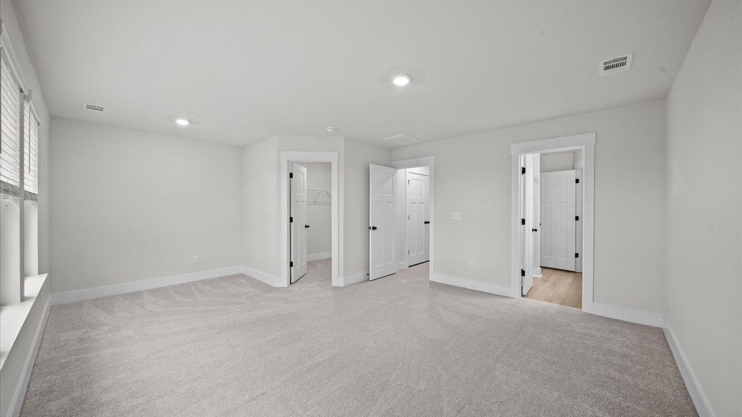 Carpeted primary suite in two story townhome at Ransdell Pointe by DRB Homes in Spartanburg, SC Carpeted primary suite in two story townhome at Ransdell Pointe by DRB Homes in Spartanburg, SC