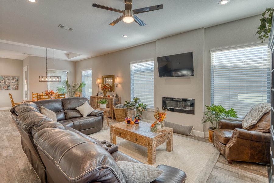 Living area featuring ceiling fan, recessed lighting, and light wood-style floors