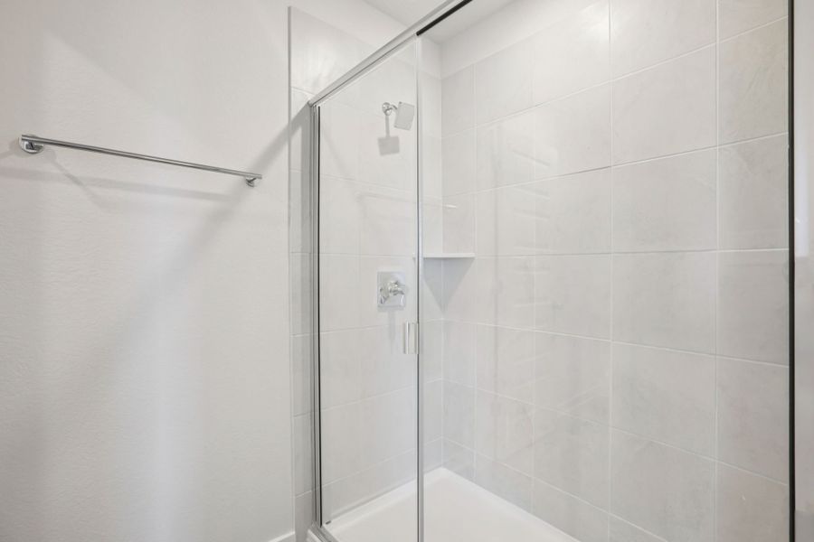 A shower with a glass door.