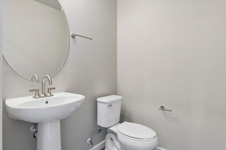A bathroom with a toilet and sink.