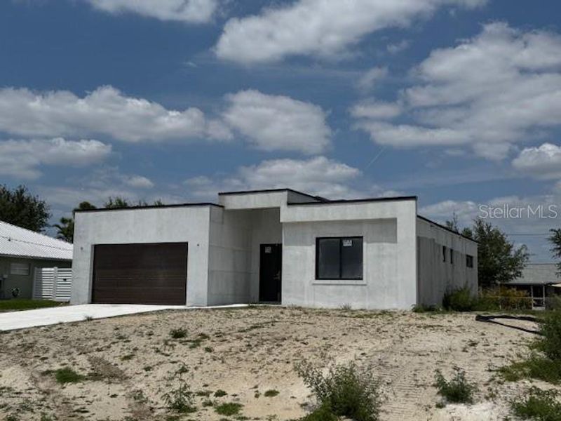 Front exterior of a new home in , Cape Coral, FL, highlighting curb appeal (Image 1). Front exterior of a new home in , Cape Coral, FL, highlighting curb appeal (Image 1).