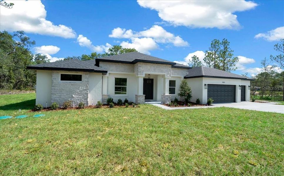 Front exterior of a new home in , Weeki Wachee, FL, highlighting curb appeal (Image 2). Front exterior of a new home in , Weeki Wachee, FL, highlighting curb appeal (Image 2).