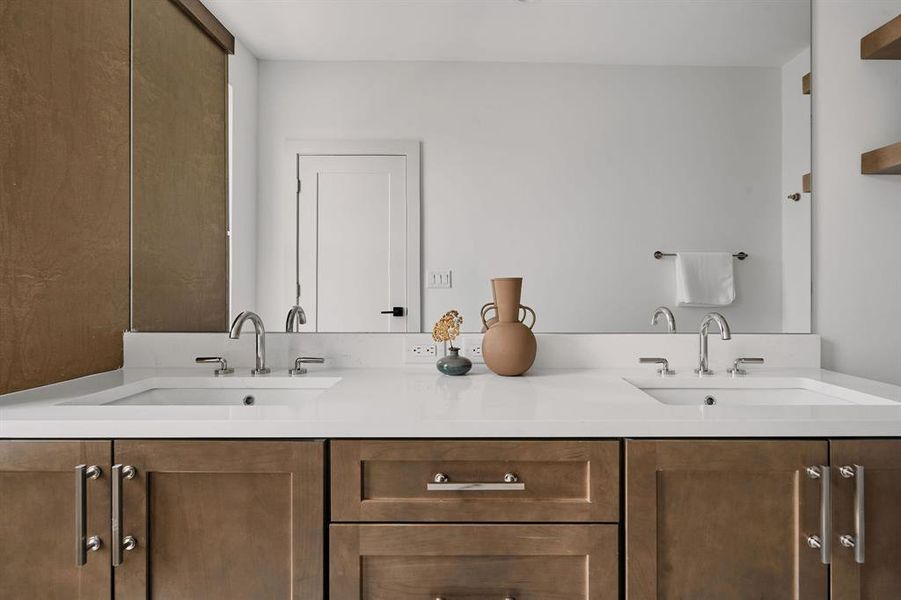 Double vanity with undermount sinks, chrome fixtures, and a white countertop