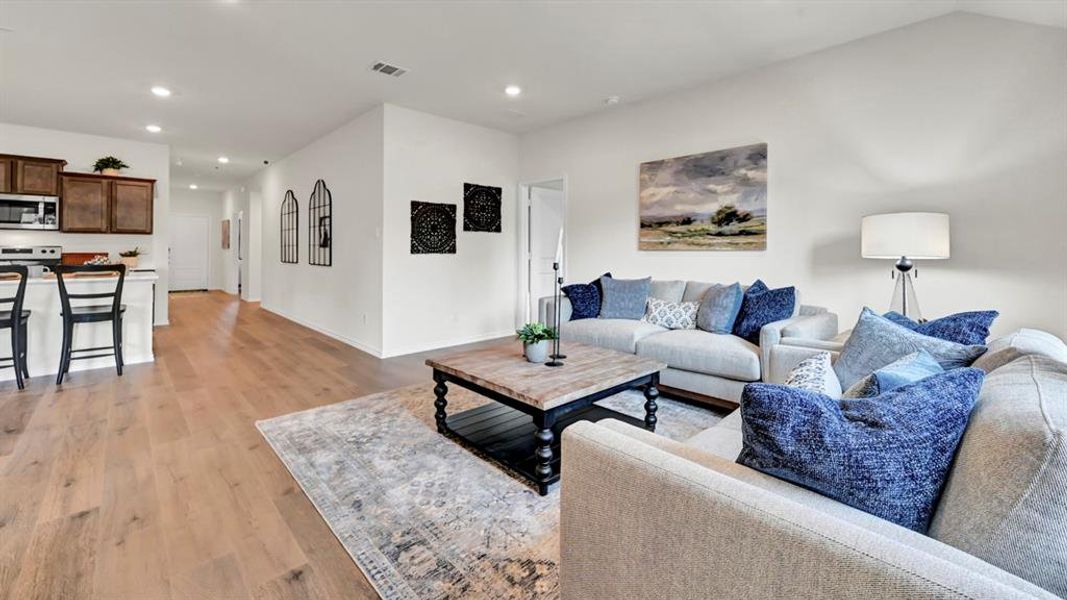 Living area featuring light wood-type flooring and recessed lighting