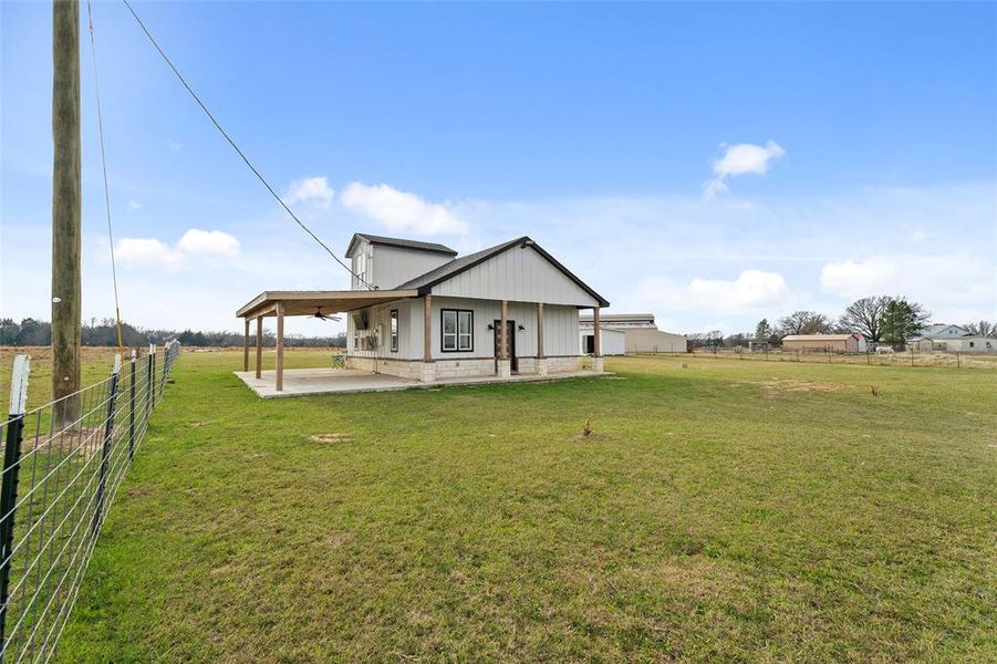 Back of property featuring a view of rural / pastoral area and covered porch