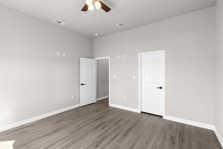 Unfurnished bedroom featuring ceiling fan and wood finished floors