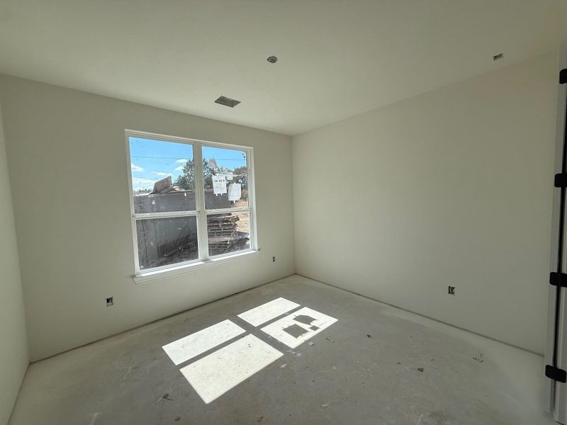 Unfurnished room featuring unfinished concrete floors