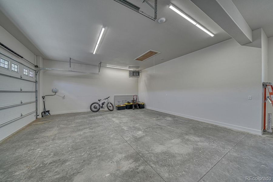 The 1,100 square foot heated garage includes epoxy flooring and three oversized doors for vehicles, equipment, and recreational gear. The 1,100 square foot heated garage includes epoxy flooring and three oversized doors for vehicles, equipment, and recreational gear.
