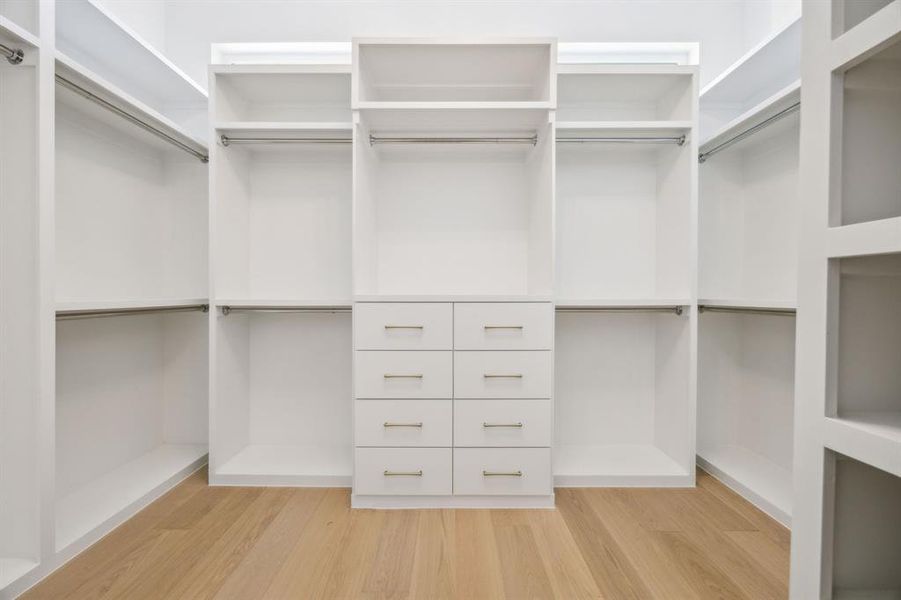 Primary closet has been finished out with wood floors and built ins. Primary closet has been finished out with wood floors and built ins.