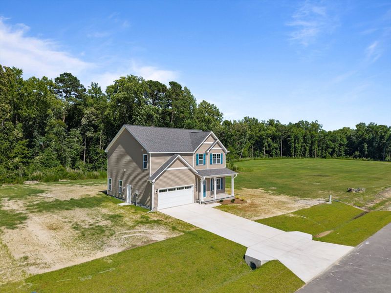 Front exterior of a new home in Laurel Oaks, Greenville, NC, highlighting curb appeal (Image 30). Front exterior of a new home in Laurel Oaks, Greenville, NC, highlighting curb appeal (Image 30).