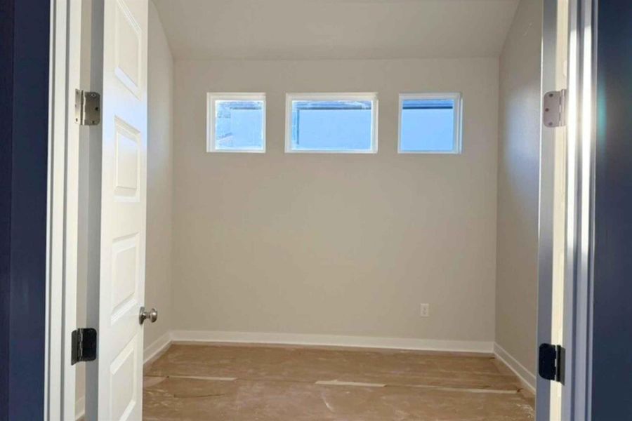 Spare room featuring plenty of natural light and wood finished floors