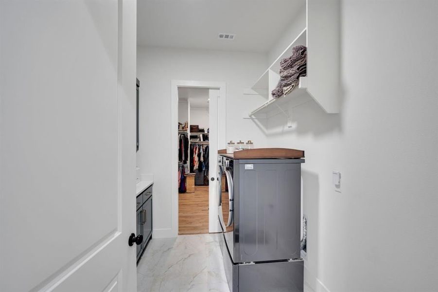 Oversized laundry room with custom built-ins
