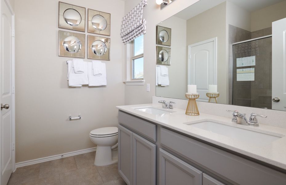 Owner's bathroom with double vanity and tile floors