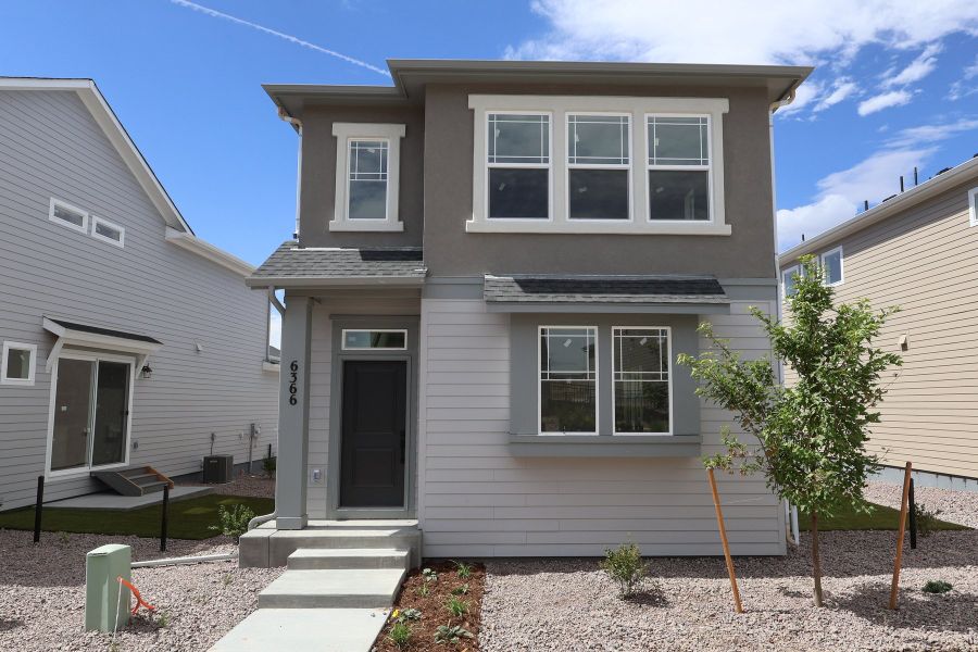 Front exterior of a new home in Revel Crossing at Wolf Ranch – The Ascent Collection, Colorado Springs, CO, highlighting curb appeal (Image 2). Front exterior of a new home in Revel Crossing at Wolf Ranch – The Ascent Collection, Colorado Springs, CO, highlighting curb appeal (Image 2).