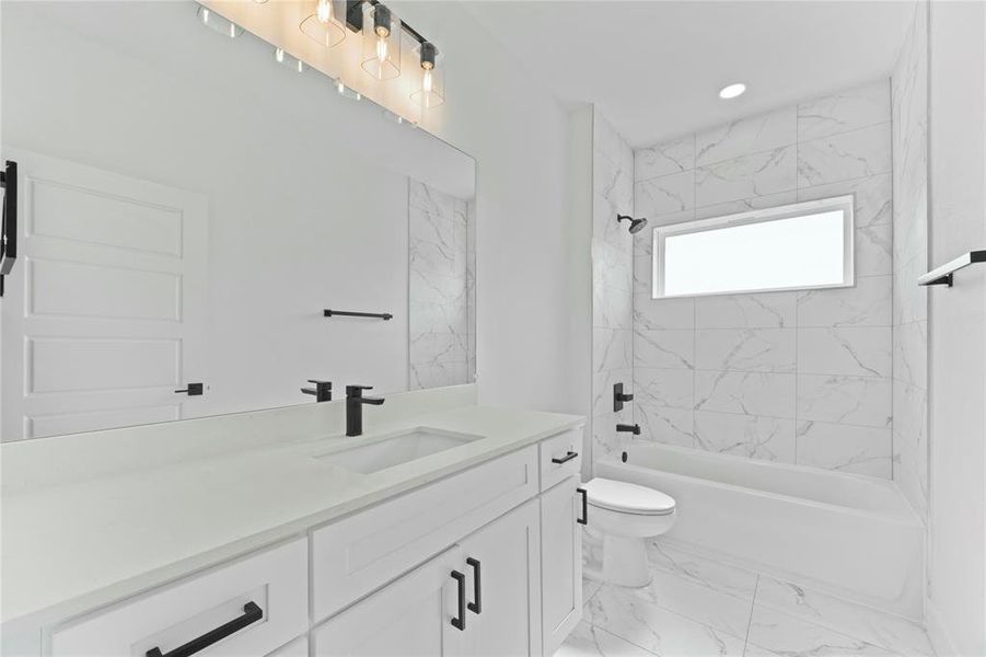 Bathroom with vanity, shower combination, and marble finish flooring Bathroom with vanity, shower combination, and marble finish flooring