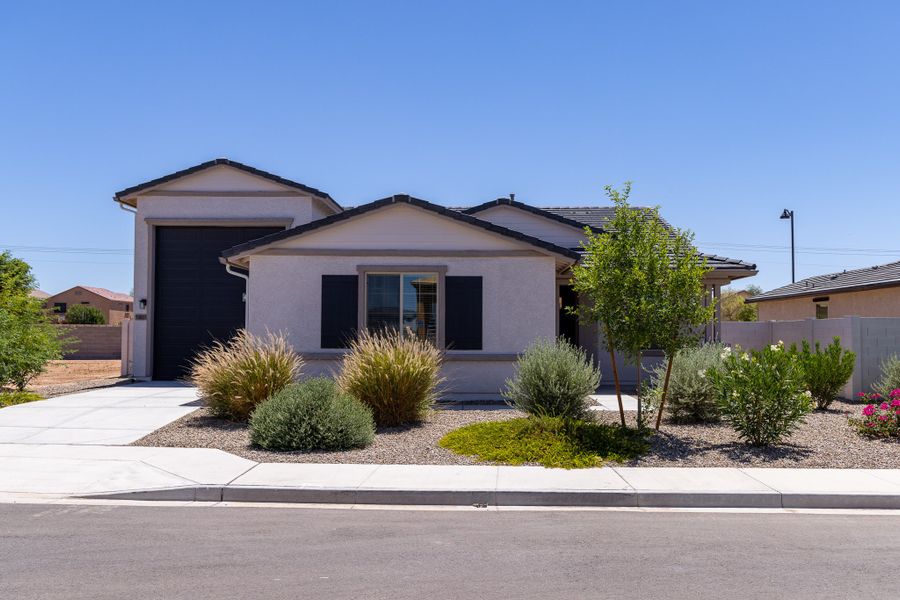 Front exterior of a new home in Rancho Mirage, Maricopa, AZ, highlighting curb appeal (Image 2). Front exterior of a new home in Rancho Mirage, Maricopa, AZ, highlighting curb appeal (Image 2).