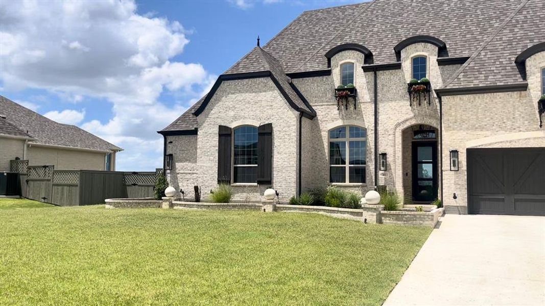 Front exterior of a new home in Pecan Square: 100ft. lots, Northlake, TX, highlighting curb appeal (Image 2). Front exterior of a new home in Pecan Square: 100ft. lots, Northlake, TX, highlighting curb appeal (Image 2).