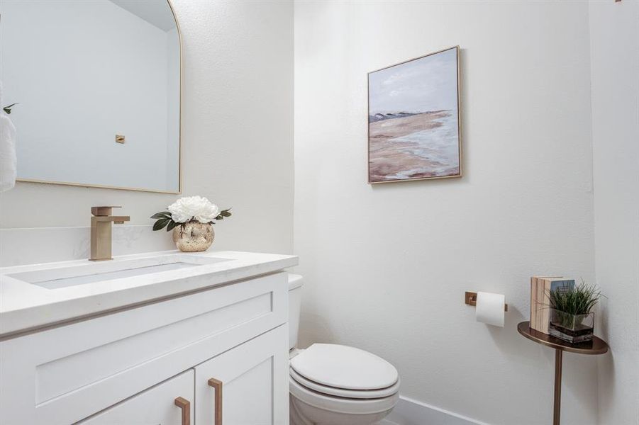 Bathroom featuring large vanity and toilet