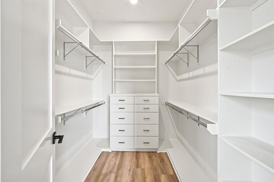 Spacious closet with built-in dresser for the primary suite. Spacious closet with built-in dresser for the primary suite.