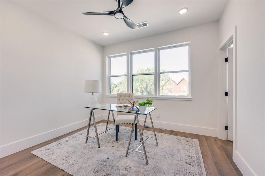 Office space featuring ceiling fan, wood finished floors, and recessed lighting Office space featuring ceiling fan, wood finished floors, and recessed lighting