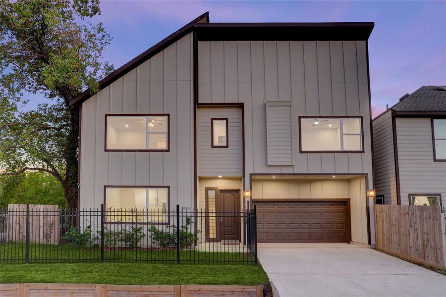 Striking modern exterior with clean lines, fully fenced yard, and welcoming entry.