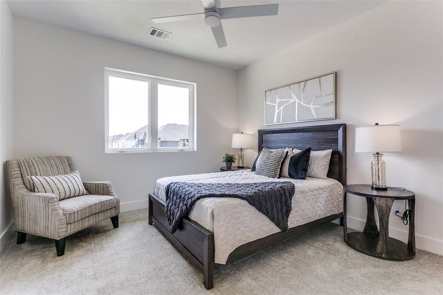 Bedroom with ceiling fan and carpet floors