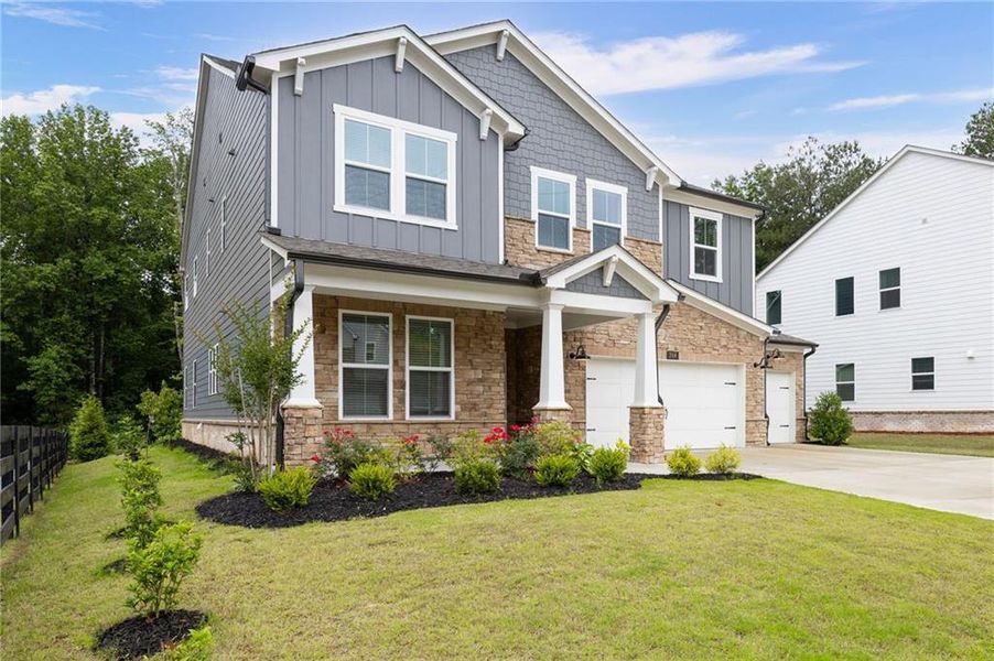Front exterior of a new home in Hillside Manor, Powder Springs, GA, highlighting curb appeal (Image 27). Front exterior of a new home in Hillside Manor, Powder Springs, GA, highlighting curb appeal (Image 27).