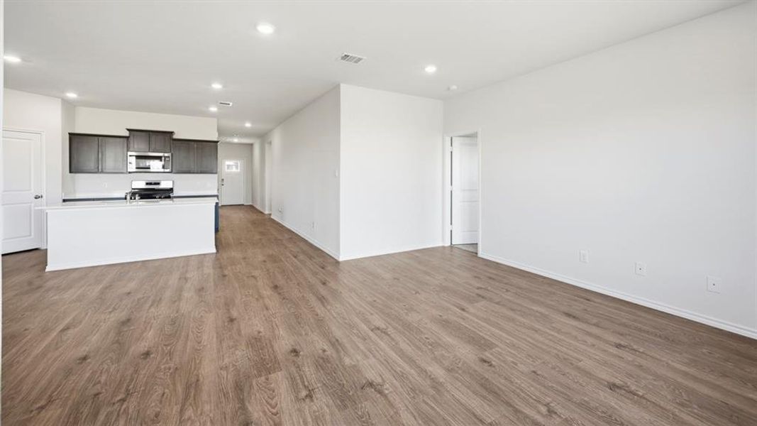 Unfurnished living room featuring light wood-type flooring and recessed lighting