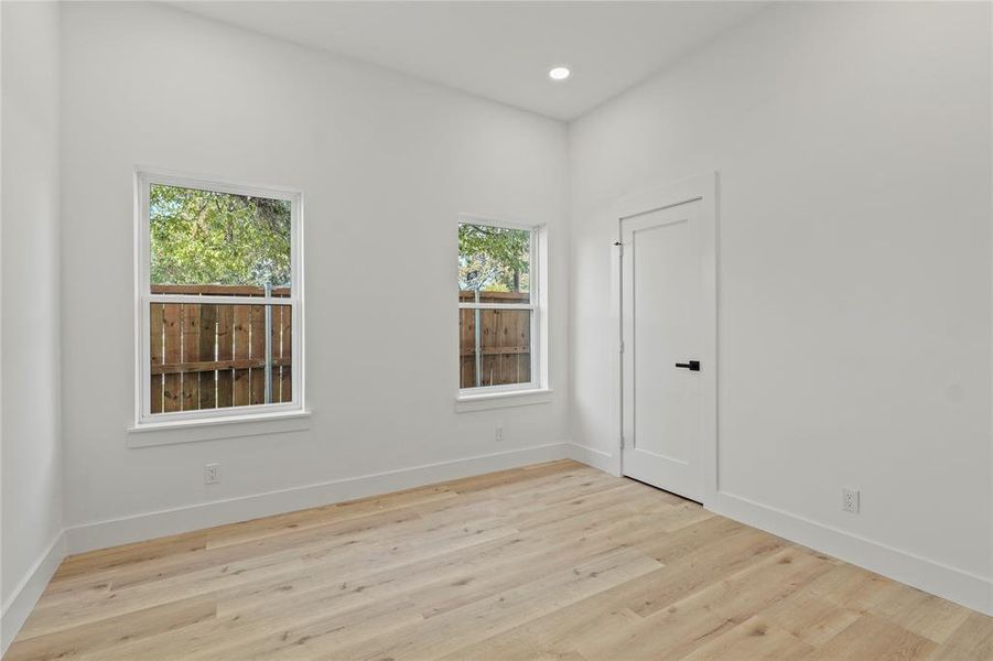 Empty room featuring light wood-type flooring and recessed lighting Empty room featuring light wood-type flooring and recessed lighting