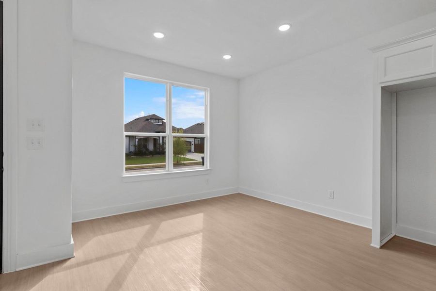 The dining area features a large window that fills the space with natural light and creates a warm, inviting atmosphere.