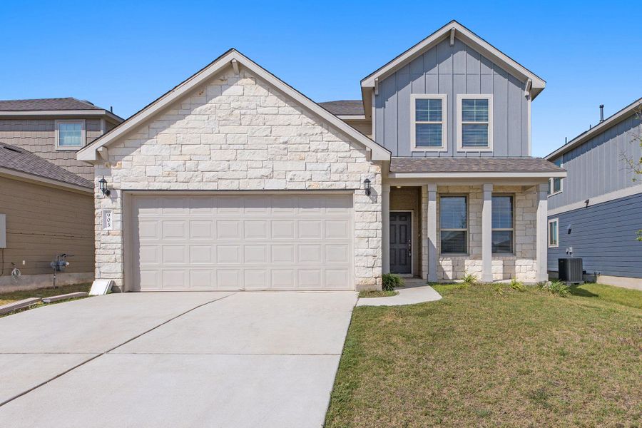 Front exterior of a new home in Carlson Place, Georgetown, TX, highlighting curb appeal (Image 1).
