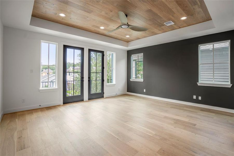 Double French doors in your primary bedroom lead to a covered balcony, overlooking your front yard.