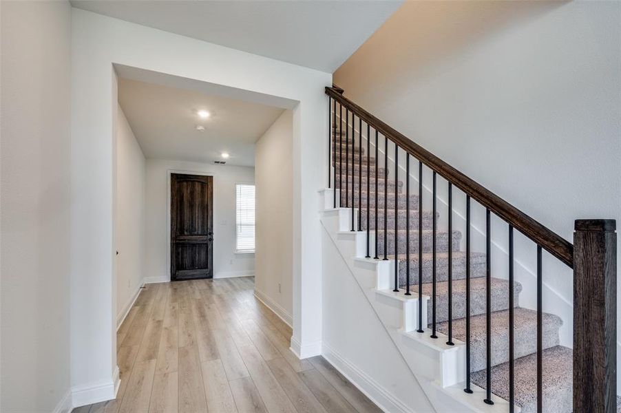 Foyer entrance with wood finished floors and stairs Foyer entrance with wood finished floors and stairs
