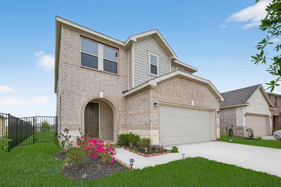 Modern white brick exterior with double garage, fresh landscaping, and a premium lot with no rear neighbors.