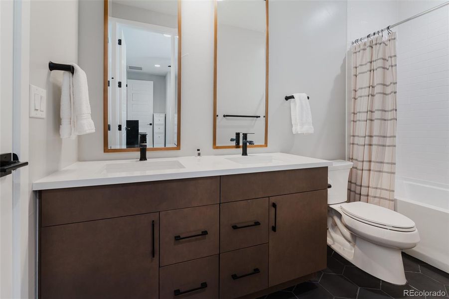 The three upper level beautifully appointed bathrooms exemplify diligent attention to detail, featuring high-end fixtures and luxurious finishes that set a standard of elegance throughout.